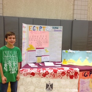 Multicultural Night at John Barry Elementary School- student posing with his display on Egypt