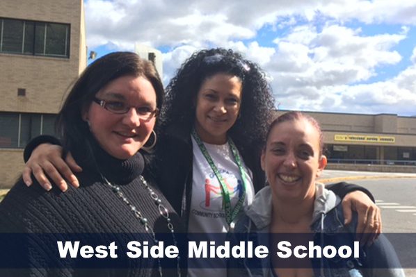 Staff posing in front of West Side Middle School